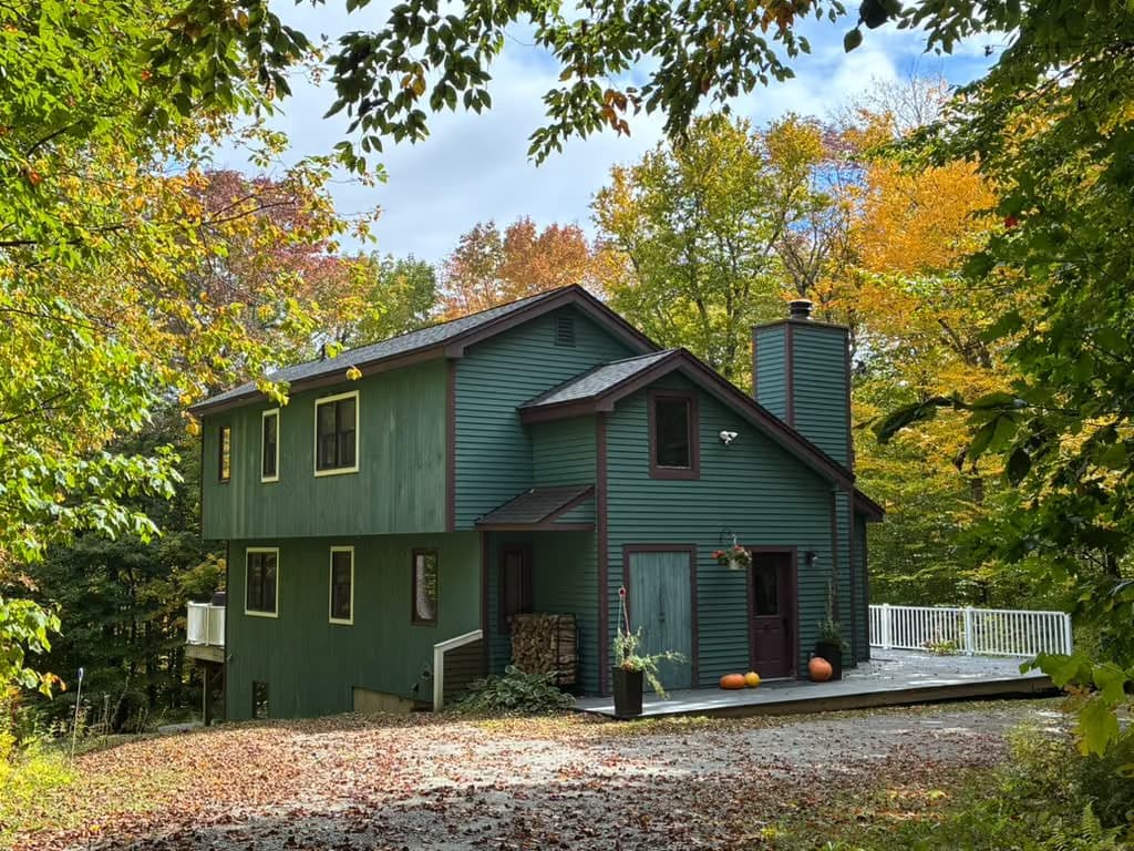 Nina's green façade framed by fall foliage